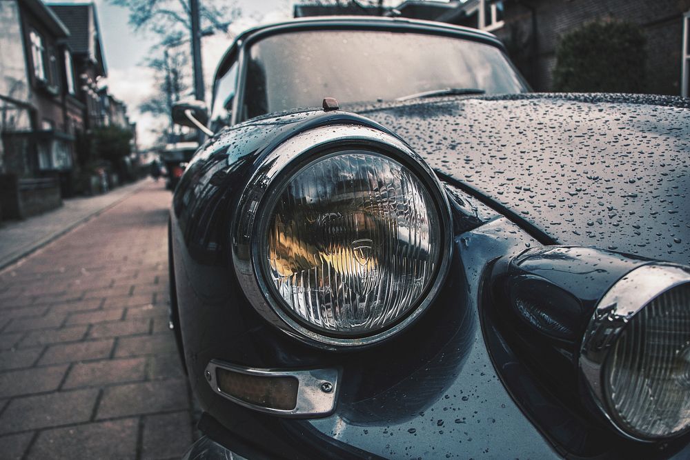 The headlight of the vintage car in the rain.. Original public domain image from Wikimedia Commons