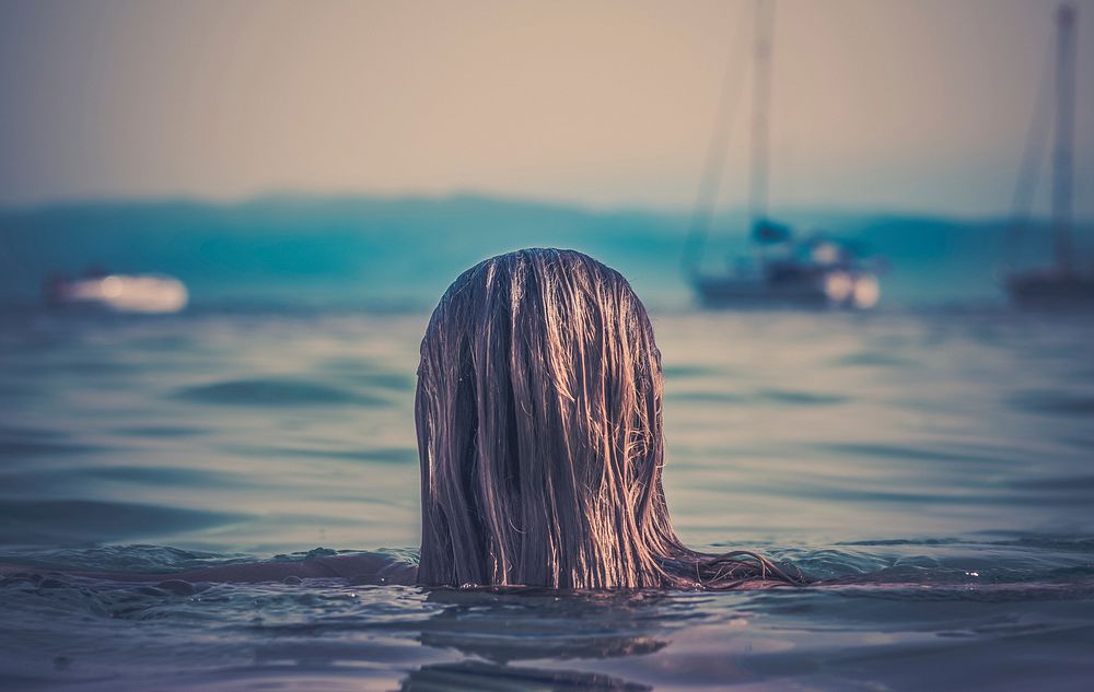 Woman with wet hair in sea. Original public domain image from Wikimedia Commons