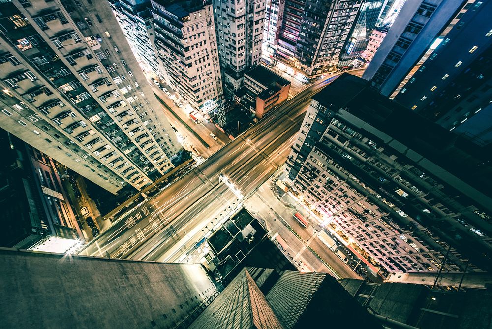 From up above, looking down on a long exposure street scene at night in Hong Kong. Original public domain image from…