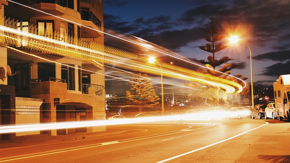 A vivid and bright shot of street lights, with light trails from a traffic timelapse. Original public domain image from…