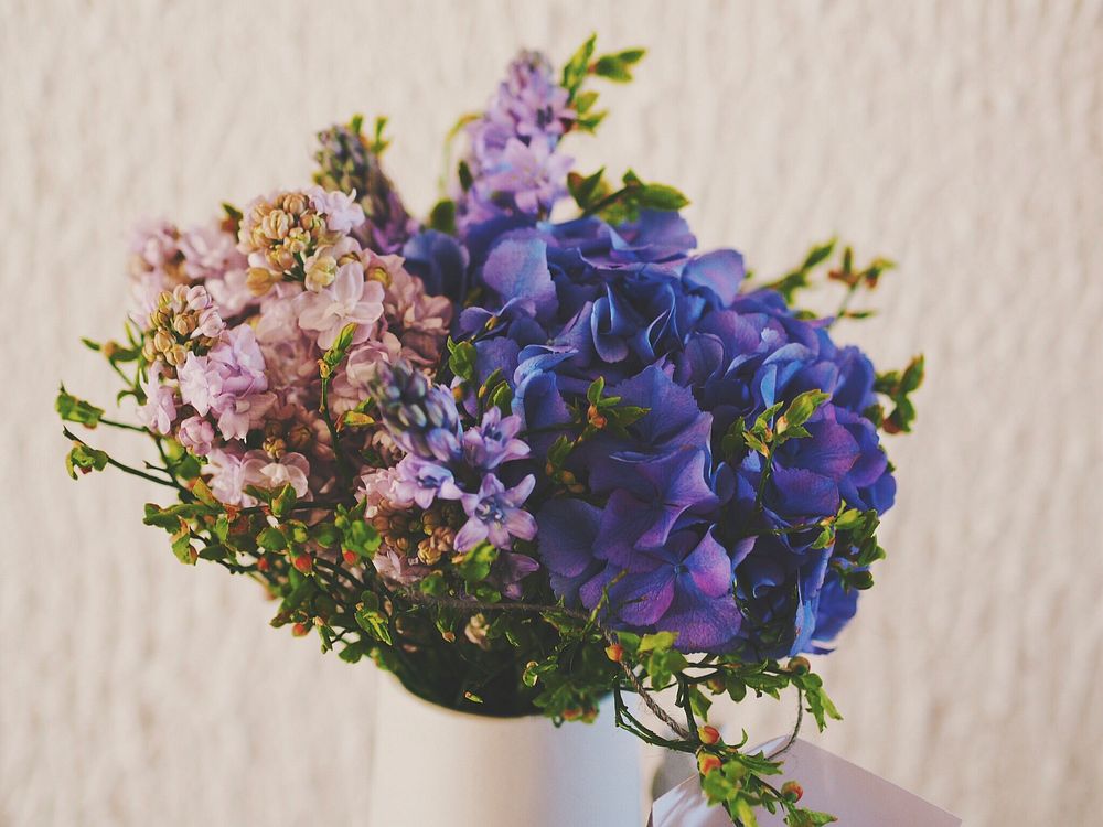 Blue hydrangea and pink lilac in white vase. Original public domain image from Wikimedia Commons