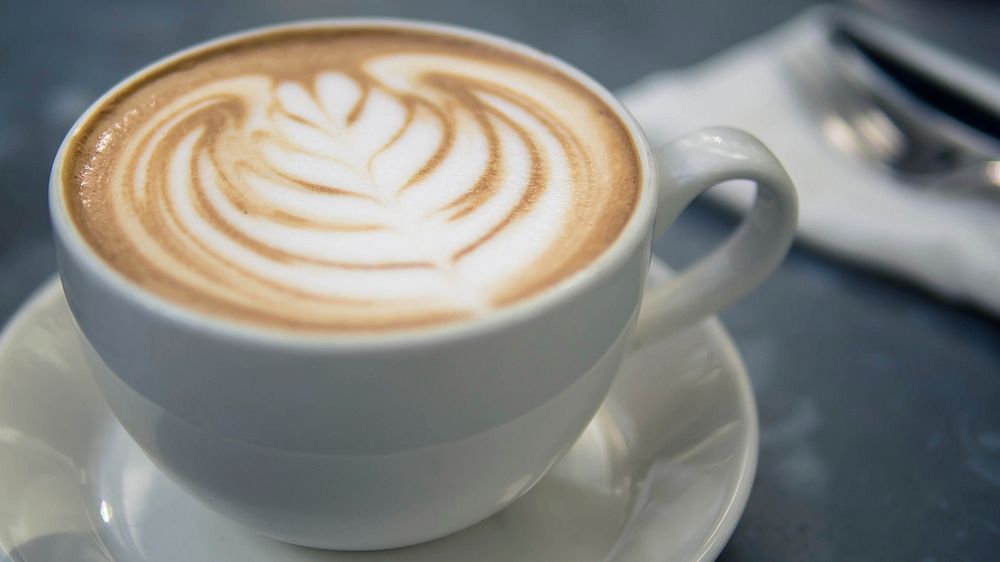 Close-up of a cup of cappuccino with latte art. Original public domain image from Wikimedia Commons