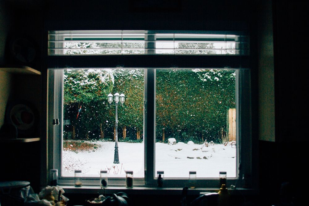 Snow covered landscape through the window. Original public domain image from Wikimedia Commons