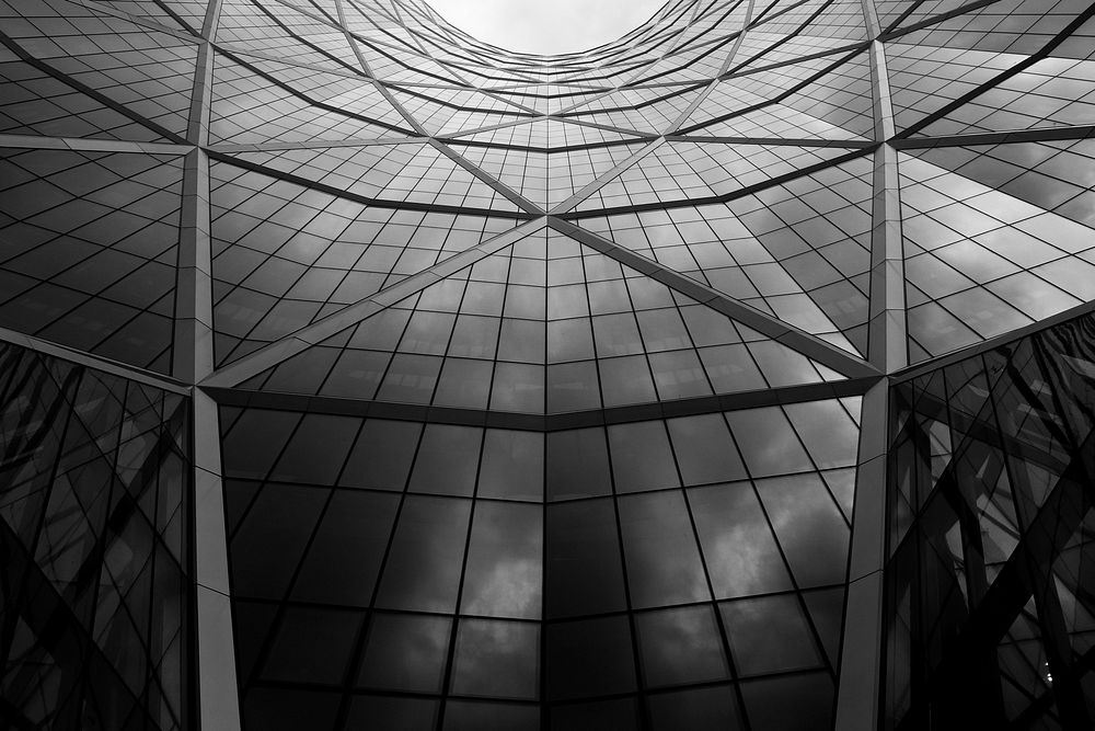 Black and white shot of glass building architecture with windows and skylight in Calgary. Original public domain image from…