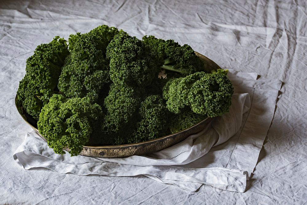 Green kale on a platter on a white tablecloth. Original public domain image from Wikimedia Commons