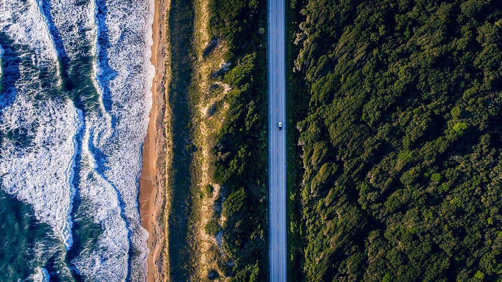Road by a coast, drone shot. Original public domain image from Wikimedia Commons