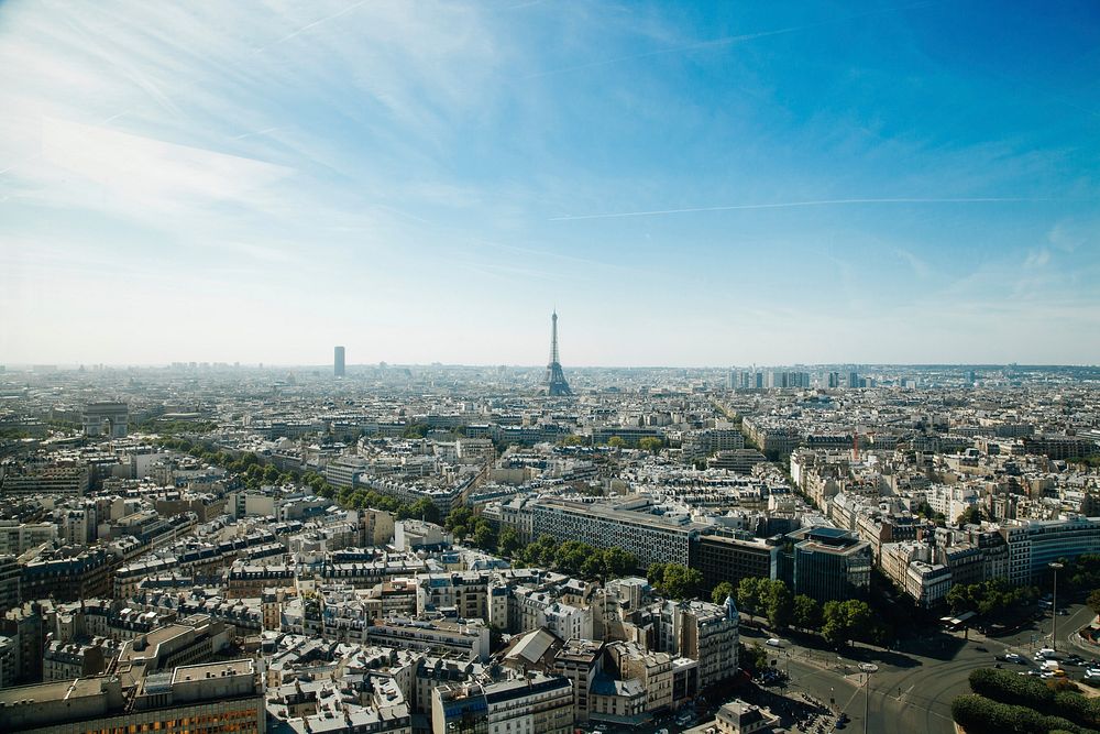 The skyline of Paris with the Eiffel Tower against a blue sky. Original public domain image from Wikimedia Commons