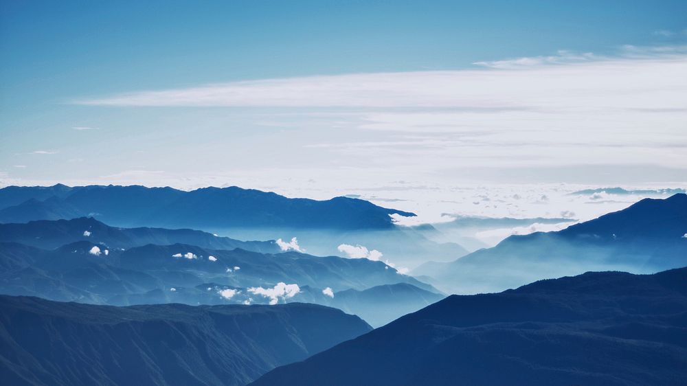 Aesthetic blue view of cloudy mountains. Original public domain image from Wikimedia Commons