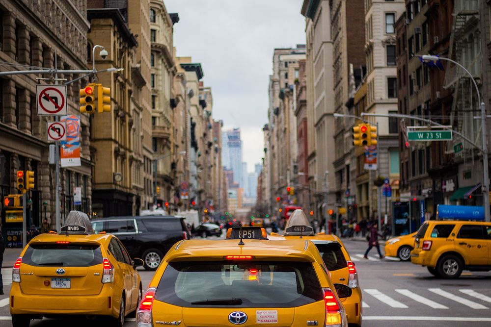 Taxi cabs stop at a red light at a busy intersection in downtown Manhattan. Original public domain image from Wikimedia…