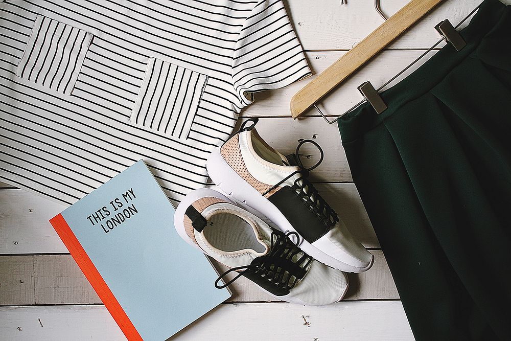 Flat lay photography comprises of women's clothes, shoes, and a notebook in London.. Original public domain image from…