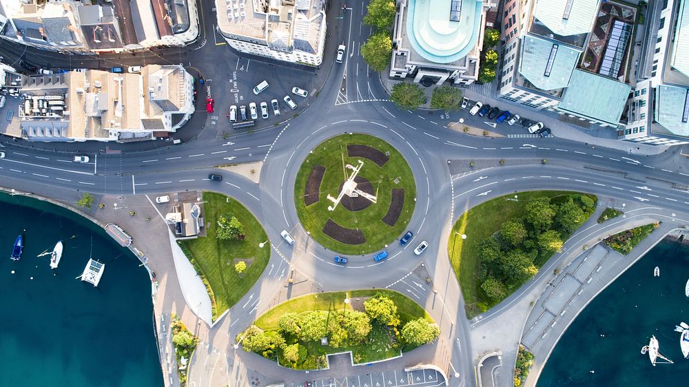 Drone view of cars going through a roundabout in the city. Original public domain image from Wikimedia Commons