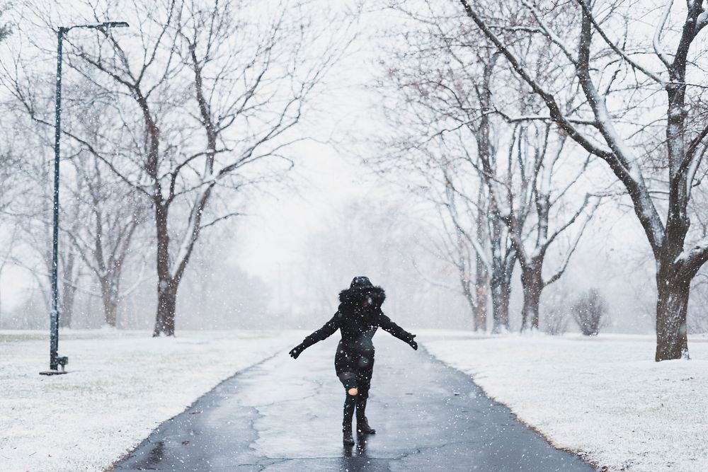 A woman running along a snow surrounded path at YWAM Kansas City. Original public domain image from Wikimedia Commons