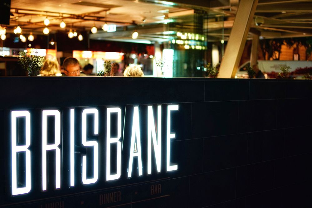 A bright white “Brisbane” neon in a club. Original public domain image from Wikimedia Commons