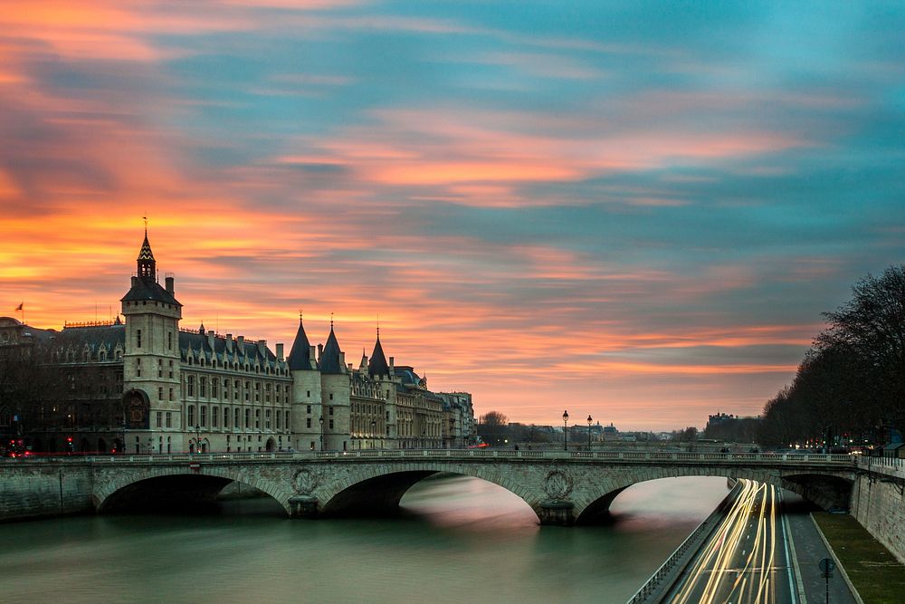 Sunset over the Loire River in Paris, near a bridge and a castle. Original public domain image from Wikimedia Commons