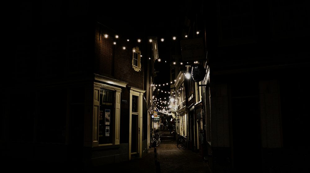 Faint lights in a dark alley in Amsterdam. Original public domain image from Wikimedia Commons