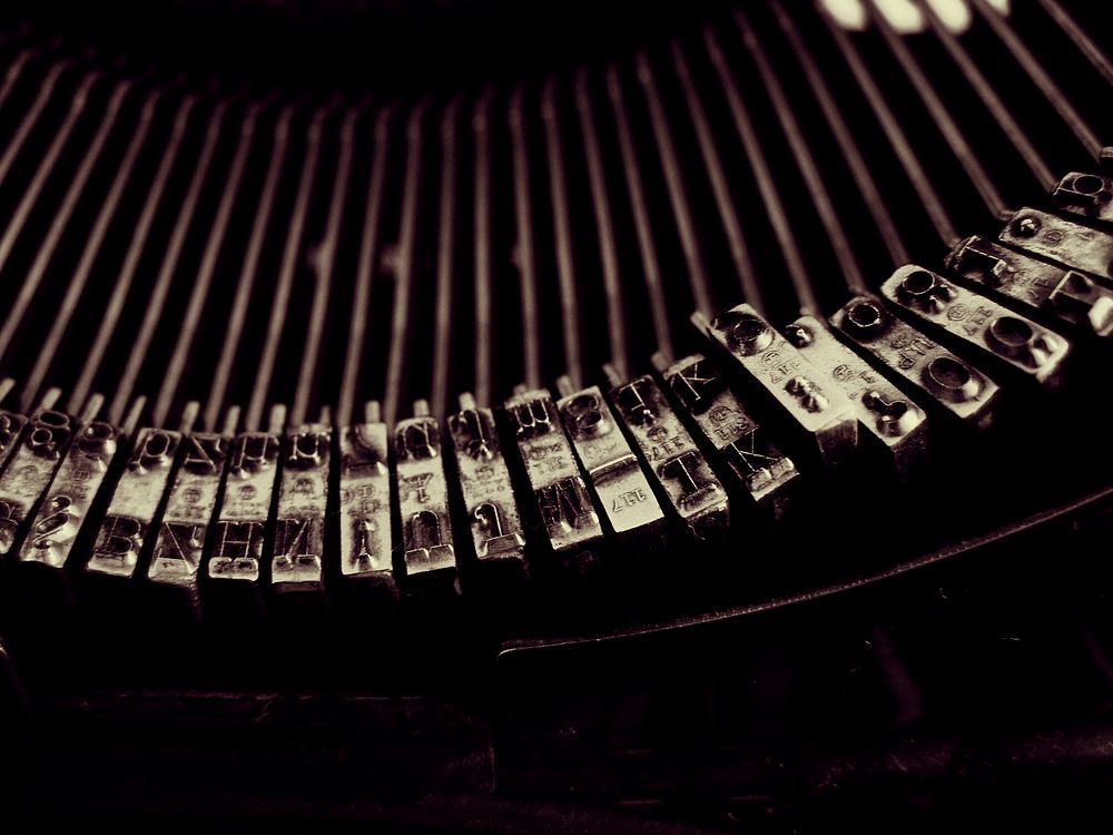 Close-up of typebars in a typewriter. Original public domain image from Wikimedia Commons