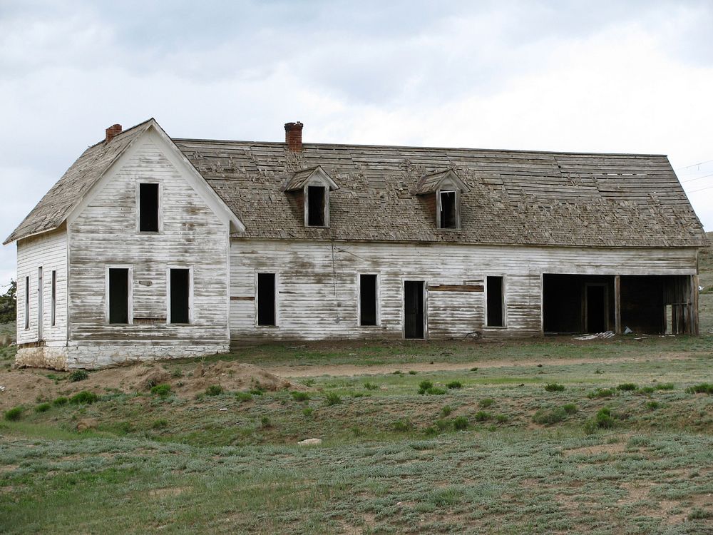 Old abandoned rural farm house with white chipped paint. Original public domain image from Wikimedia Commons