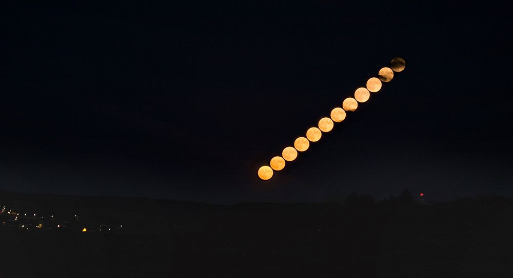 Lunar eclipse photo sequence in dark sky.Original public domain image from Wikimedia Commons
