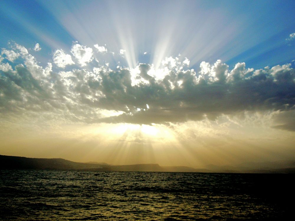 Sunrays, cloud, ocean, blue sky. Original public domain image from Wikimedia Commons
