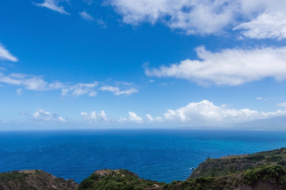 View from the cliff with blue ocean and cloudy sky. Original public domain image from Wikimedia Commons