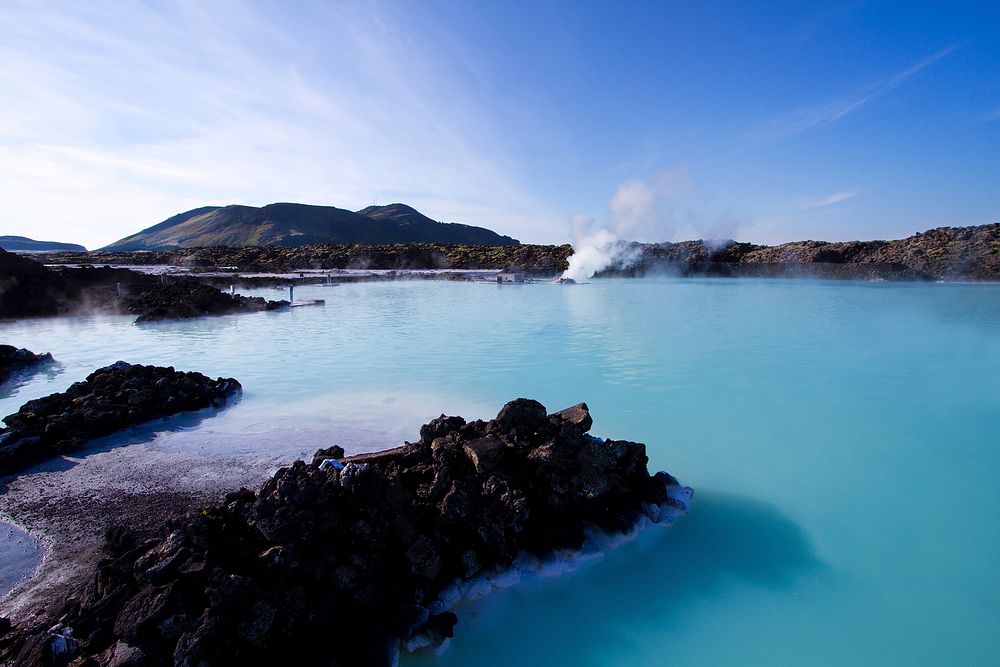 Clear blue water and sky with hot rock spring in Blue Lagoon spa, Reykjavik Iceland. Original public domain image from…