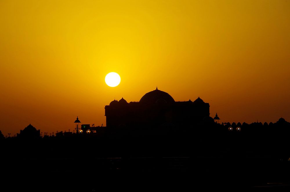 Silhouette of a mask at orange sunset in Abu Dhabi. Original public domain image from Wikimedia Commons
