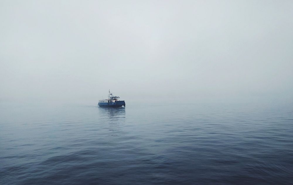 Working boat crosses a foggy sea in Amsterdam. Original public domain image from Wikimedia Commons