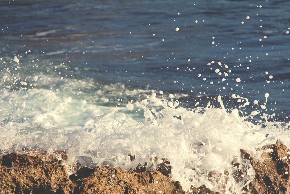 Close up sea wave splashing on the rock. Original public domain image from Wikimedia Commons