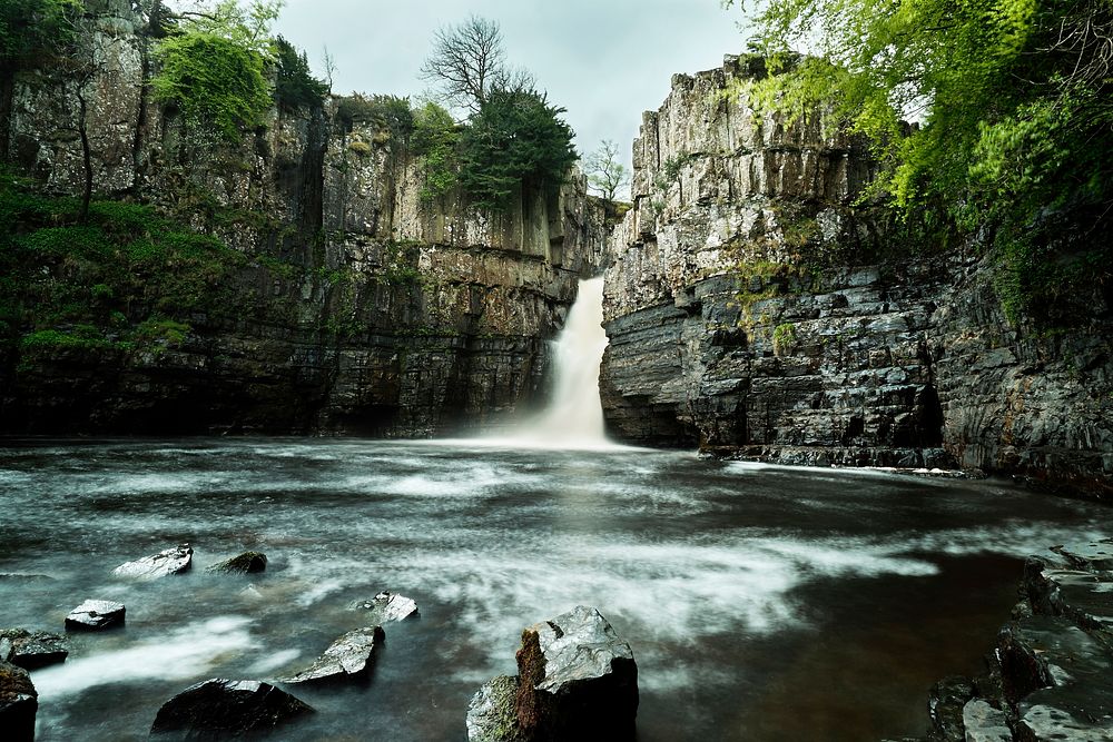 A view of the High Force Waterfall in England, flowing through a canyon and into a gorge. Original public domain image from…
