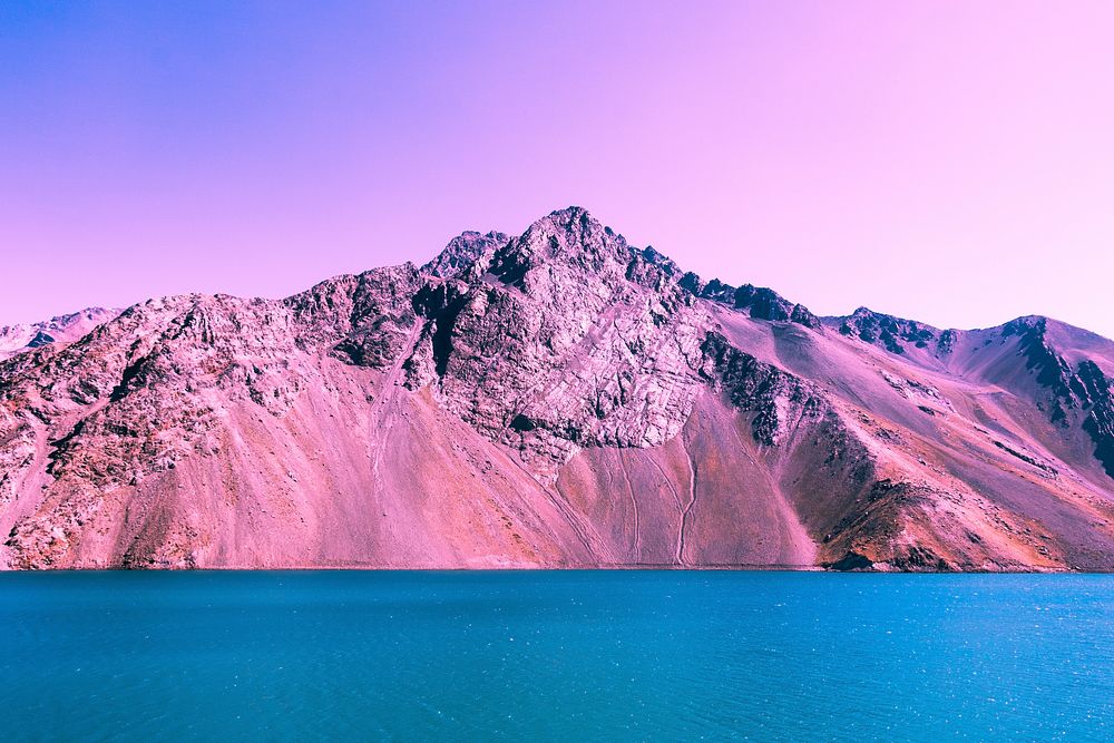 Pink and purple mountain ridge by a blue lake. Original public domain image from Wikimedia Commons