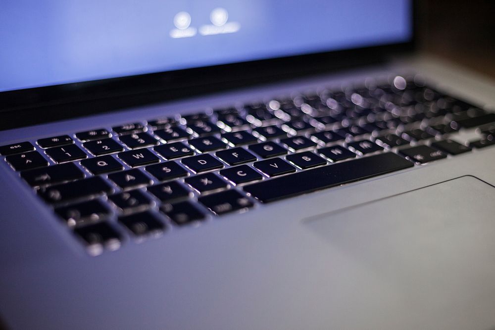 Close-up of a backlit laptop keyboard. Original public domain image from Wikimedia Commons