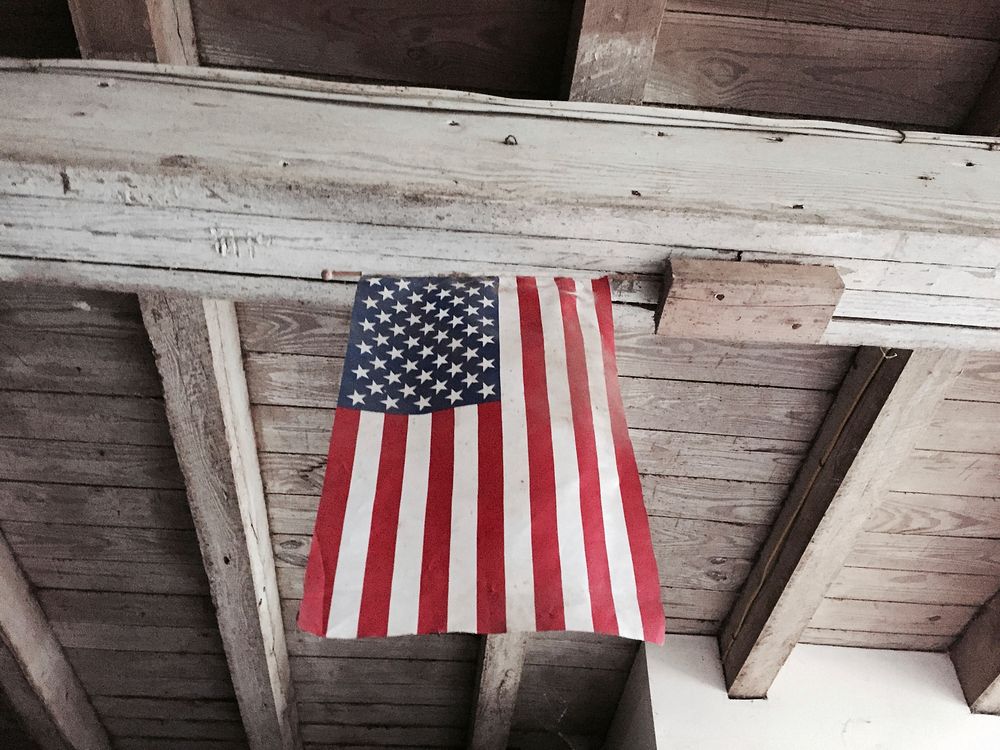 The American flag hanging from a wooden ceiling. Original public domain image from Wikimedia Commons