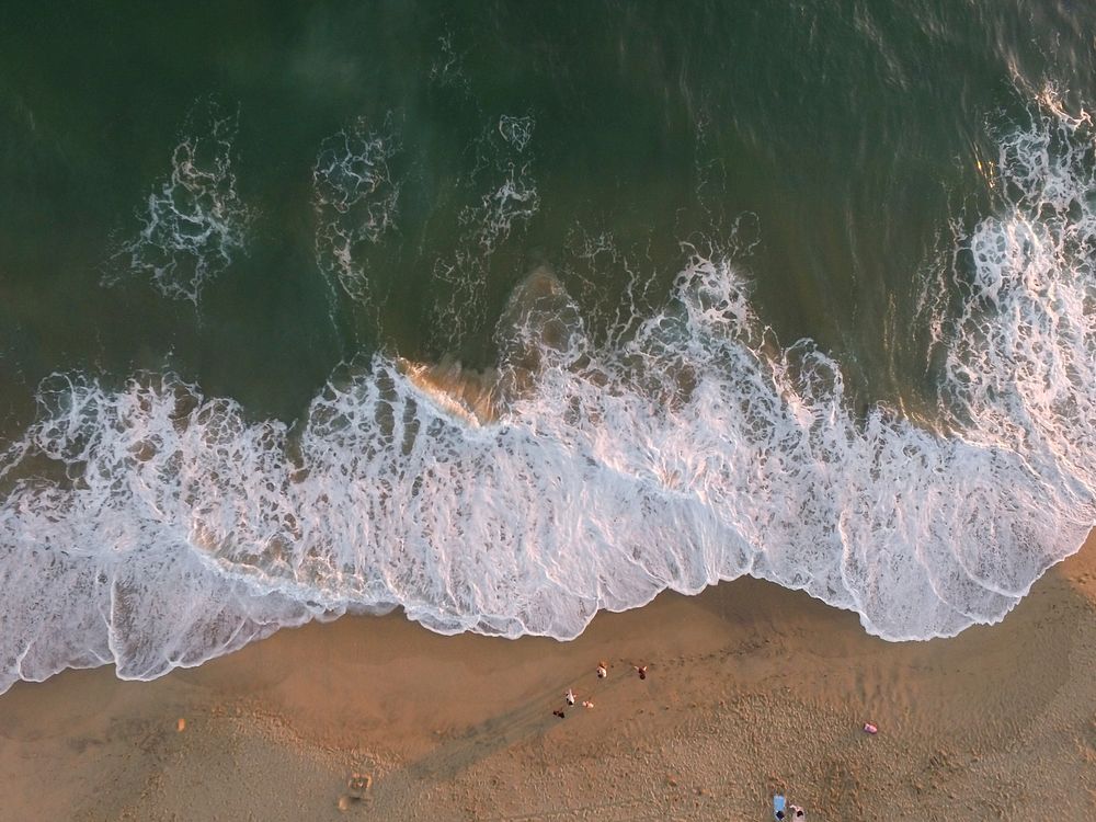 Ocean waves washing sandy beach, drone view, aerial view. Original public domain image from Wikimedia Commons