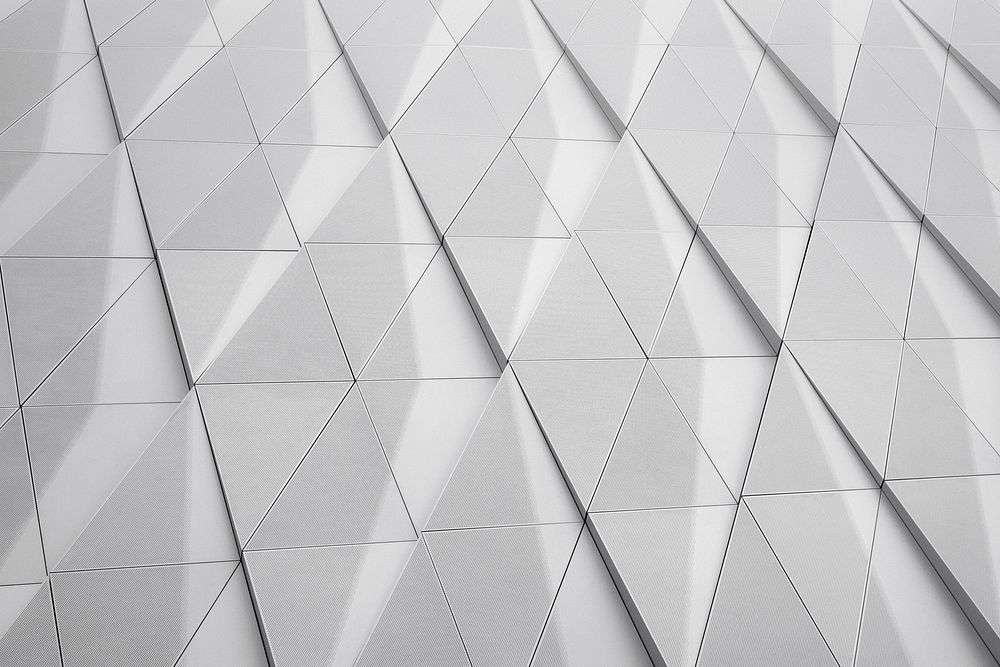 A white facade with a geometric pattern made up of triangles. Original public domain image from Wikimedia Commons