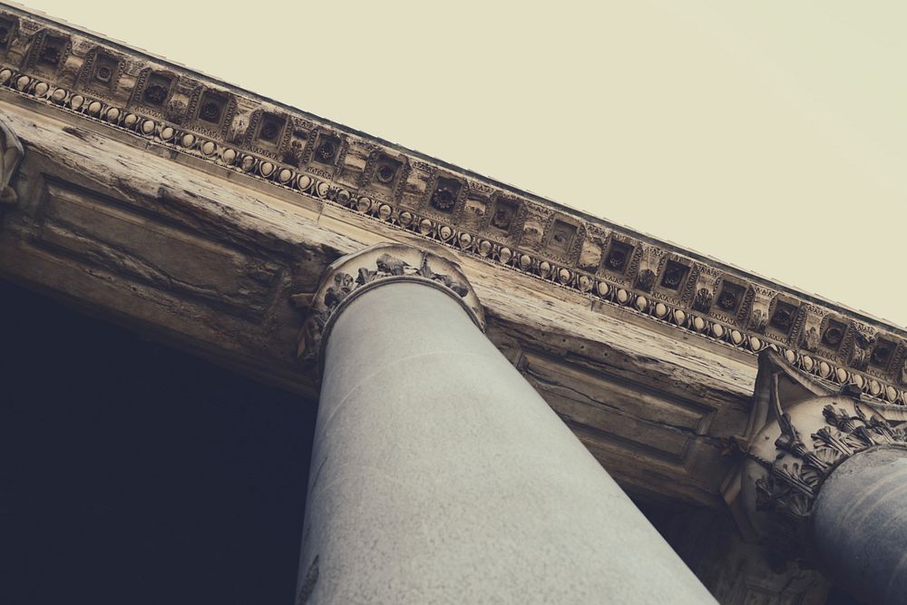 A shot looking up at a pillar with greek architectural features. Original public domain image from Wikimedia Commons