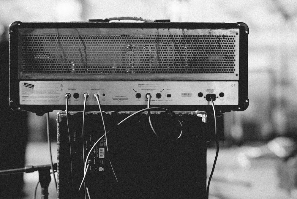 Black and white close up of shot of amplifier with cables and cords. Original public domain image from Wikimedia Commons