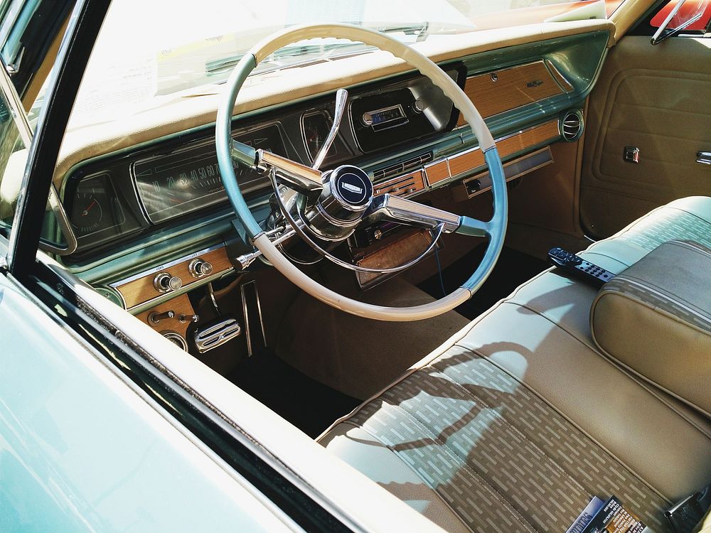 Steering wheel and dashboard of the vintage automobile.. Original public domain image from Wikimedia Commons