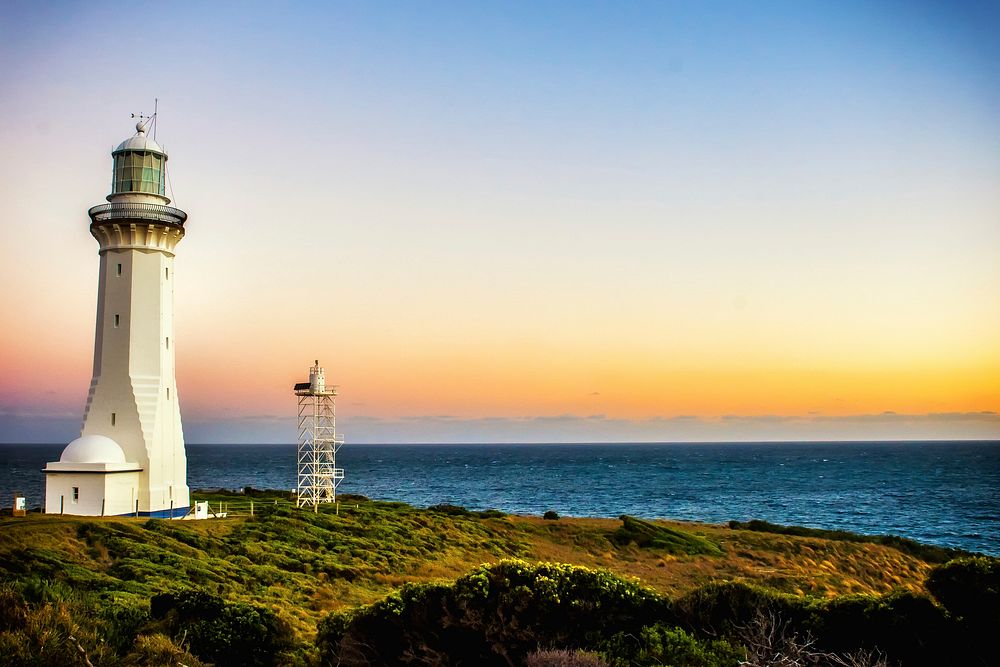 Beautiful lighthouse by the beach. Original public domain image from Wikimedia Commons