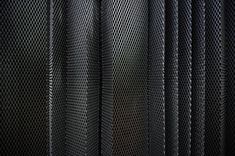 A metal criss-cross grid in undulating layers. Original public domain image from Wikimedia Commons