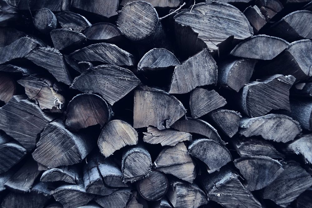 A stack of gray-hued lumber. Original public domain image from Wikimedia Commons