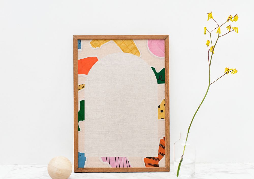 Wooden picture frame with ripped paper collage