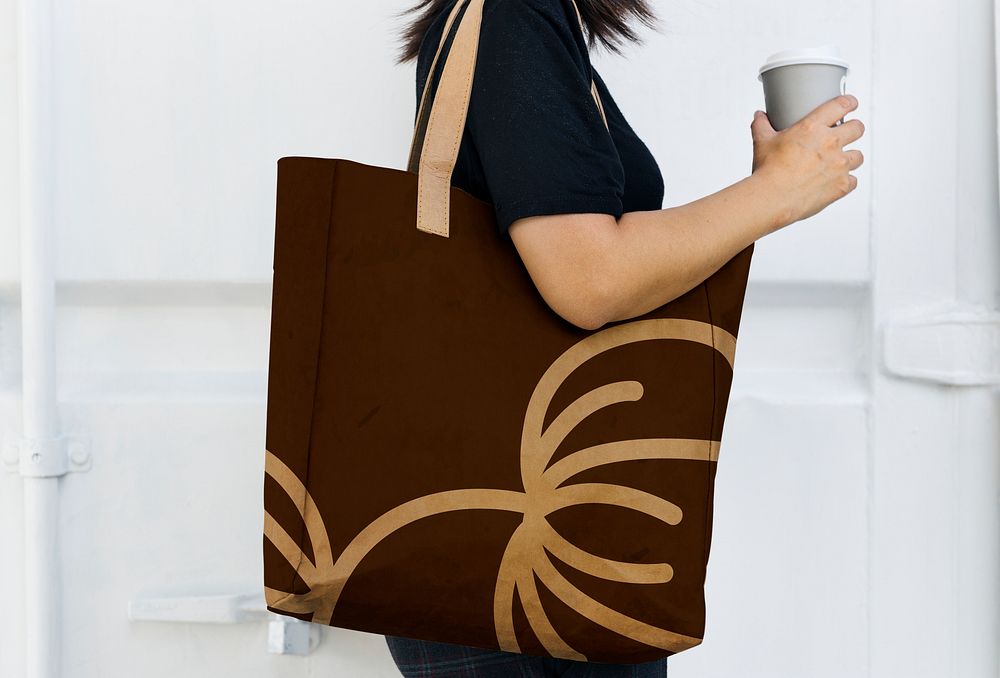 Woman with a brown tote bag side view