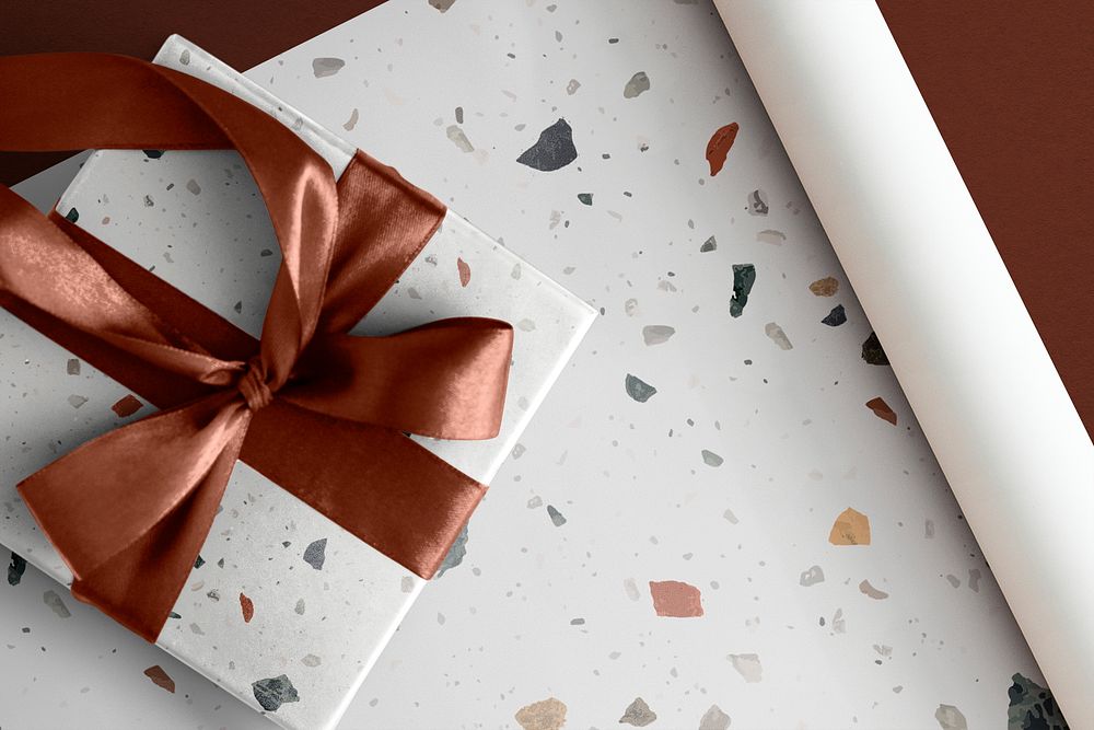 White Terrazzo wrap paper, gift box with red ribbon, flat lay