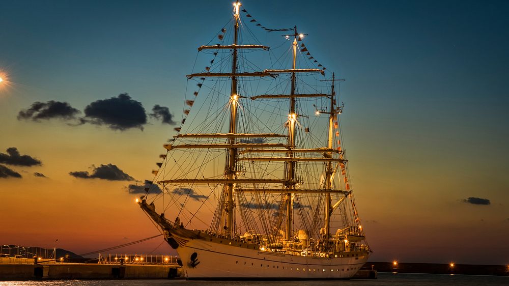 Romanian sail training ship Mircea berthed in a harbour at night. Original public domain image from Wikimedia Commons