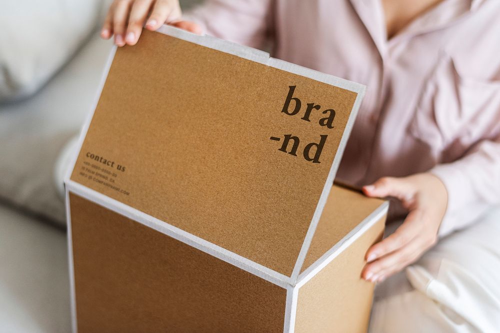 Woman unpacking brown box in the living room