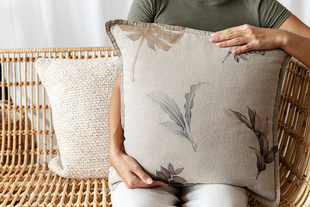 Floral beige cushion held by a woman interior design