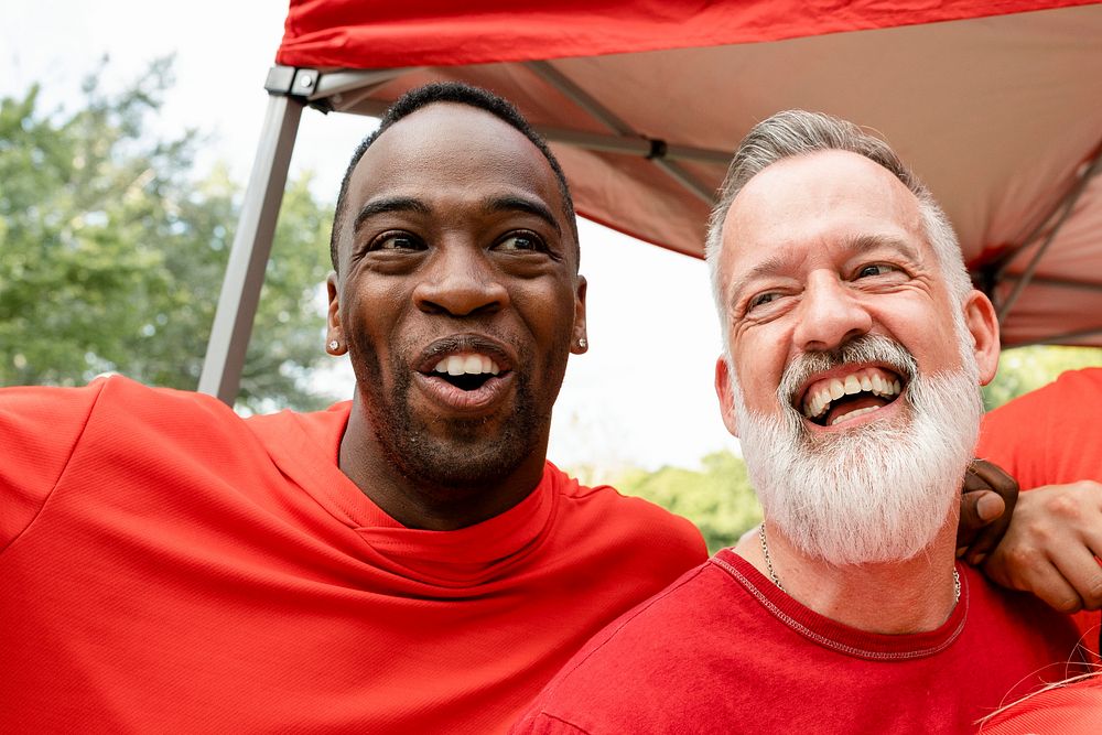 Cheerful men hugging at a tailgate party