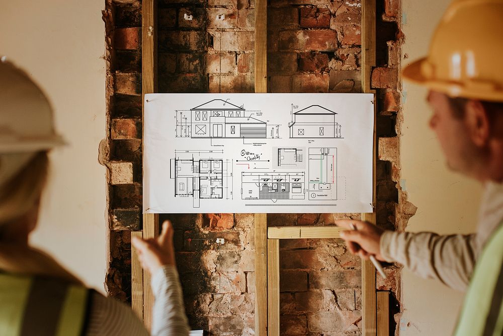 Woman and man contractor reading floor plan together