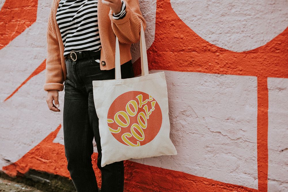 Woman carrying reusable canvas tote bag 