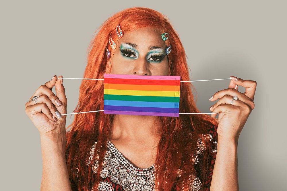 Drag queen holding rainbow face mask in the new normal